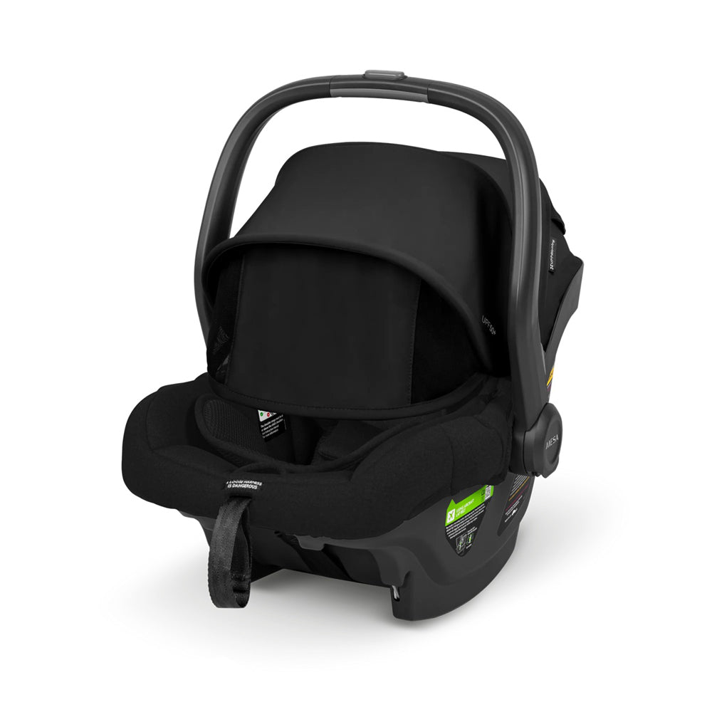 The UPPAbaby Mesa Car Capsule, in black, features a sunshade canopy, carrying handle, safety labels, soft padded interior, and a secure front strap—perfect for infant travel in Australia.
