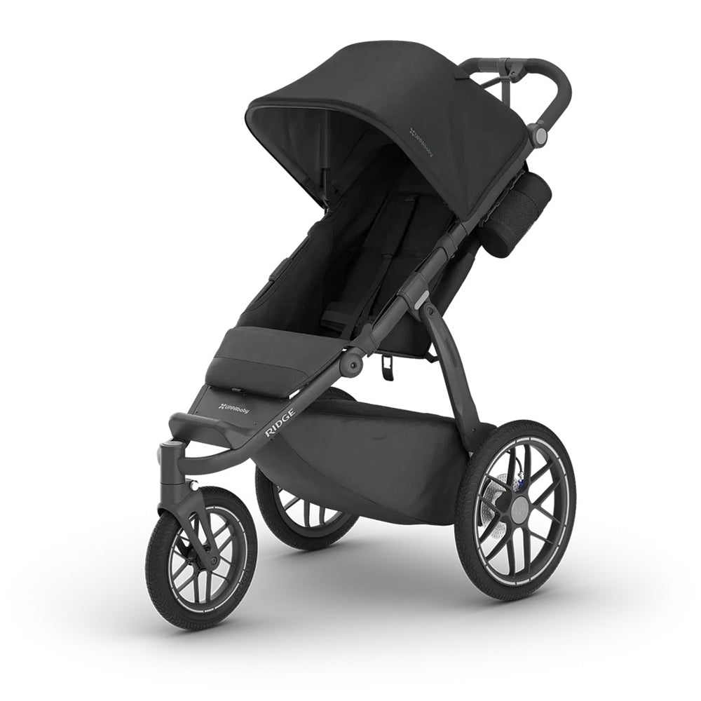 The UPPAbaby RIDGE V2 Stroller - JAKE is a black, three-wheeled jogging stroller with a UPF 50+ canopy, sturdy frame, storage basket, smaller front wheel, and cup holder—ideal for active parents.