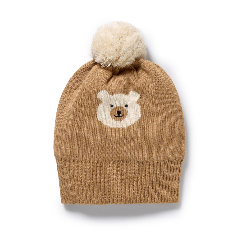 The Wilson & Frenchy Beary Cute Organic Knitted Jacquard Hat features a tan jacquard knit, ribbed brim, white pom-pom, and an adorable bear face—making it the perfect cozy organic cotton baby hat.