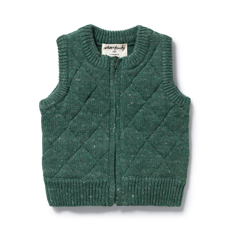 The Wilson & Frenchy Clover Organic Knitted Vest is a green, sleeveless baby vest made from organic cotton, featuring a quilted diamond pattern, ribbed edges, front zipper, and neckline fabric tag—perfect for cozy layering.