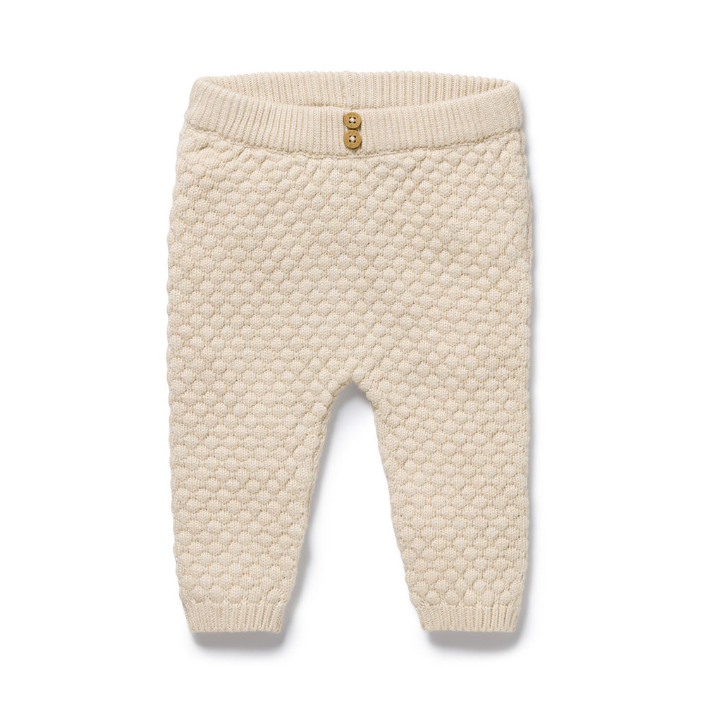 The Wilson & Frenchy Cream Organic Knitted Bubble Legging features a textured honeycomb pattern, ribbed waistband and cuffs, and two front decorative buttons. Displayed flat on a white background.