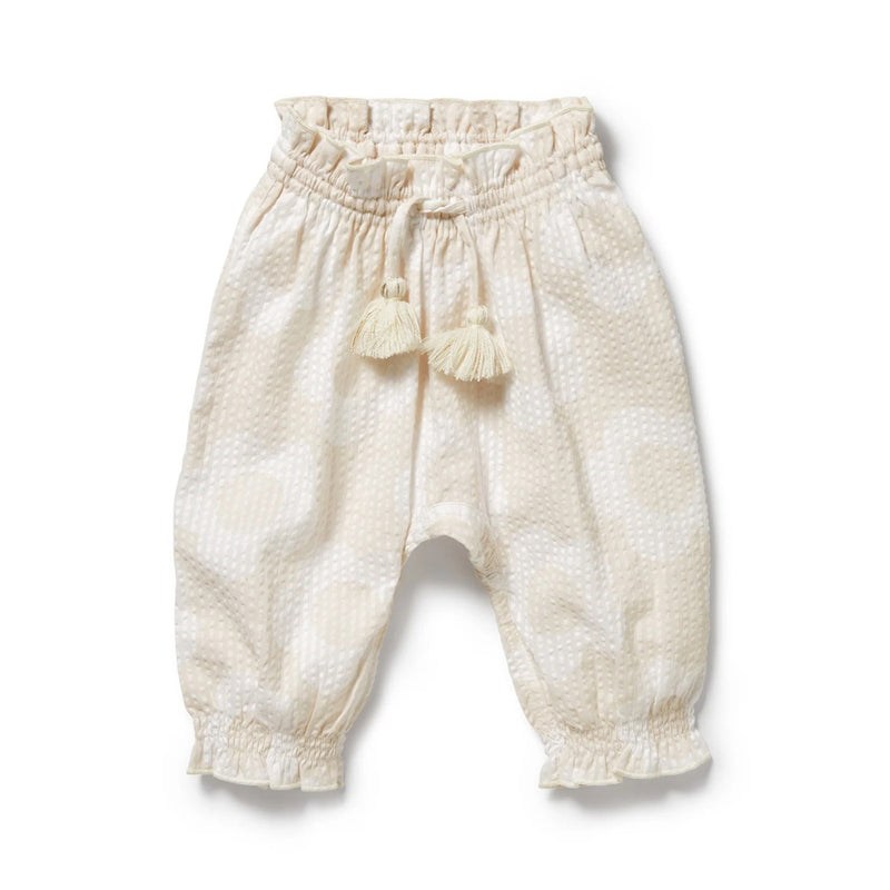 The Wilson & Frenchy Daisy Bloom Organic Pant features cream cotton seersucker, a subtle textured pattern, elastic waistband with cream tassel ties, and elastic cuffs. Soft and comfy for infants—ideal for summer wear.