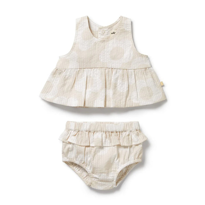 The Wilson & Frenchy Daisy Bloom Organic Ruffle Set features a cream-colored, sleeveless ruffled top and matching bloomers with a subtle dot pattern, crafted from organic cotton for stylish charm.