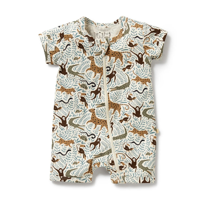 The Wilson & Frenchy Mini Jungle Organic Boyleg Zipsuit is a GOTS-certified organic cotton baby romper with short sleeves, a front zipper, and an off-white jungle print featuring cheetahs, monkeys, and leafy branches in earthy tones.