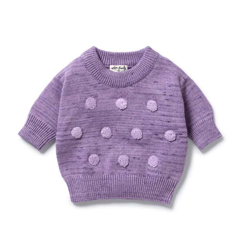 The Wilson & Frenchy Mulberry Organic Knitted Bauble Jumper is crafted from soft organic cotton and features a ribbed collar, cuffs, and hem with rows of raised pom-poms on the front.