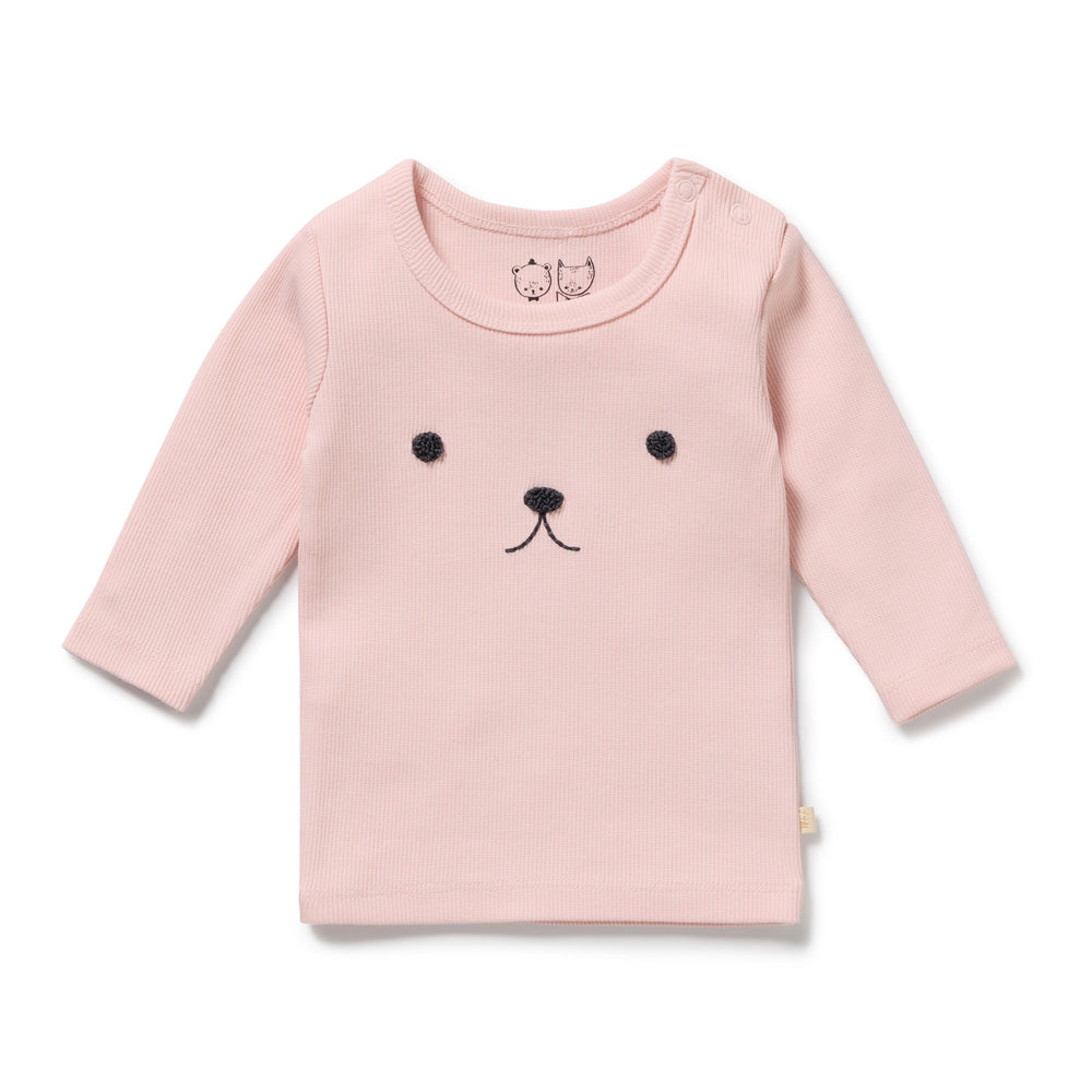 The Wilson & Frenchy Strawberry Cream Organic Rib Top is a light pink, long-sleeve rib cotton top with simple black bear embroidery and two snaps on the shoulder for easy dressing.