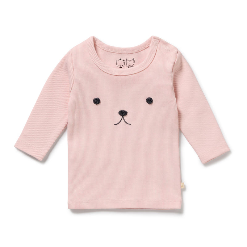 The Wilson & Frenchy Strawberry Cream Organic Rib Top is a light pink, long-sleeve rib cotton top with simple black bear embroidery and two snaps on the shoulder for easy dressing.