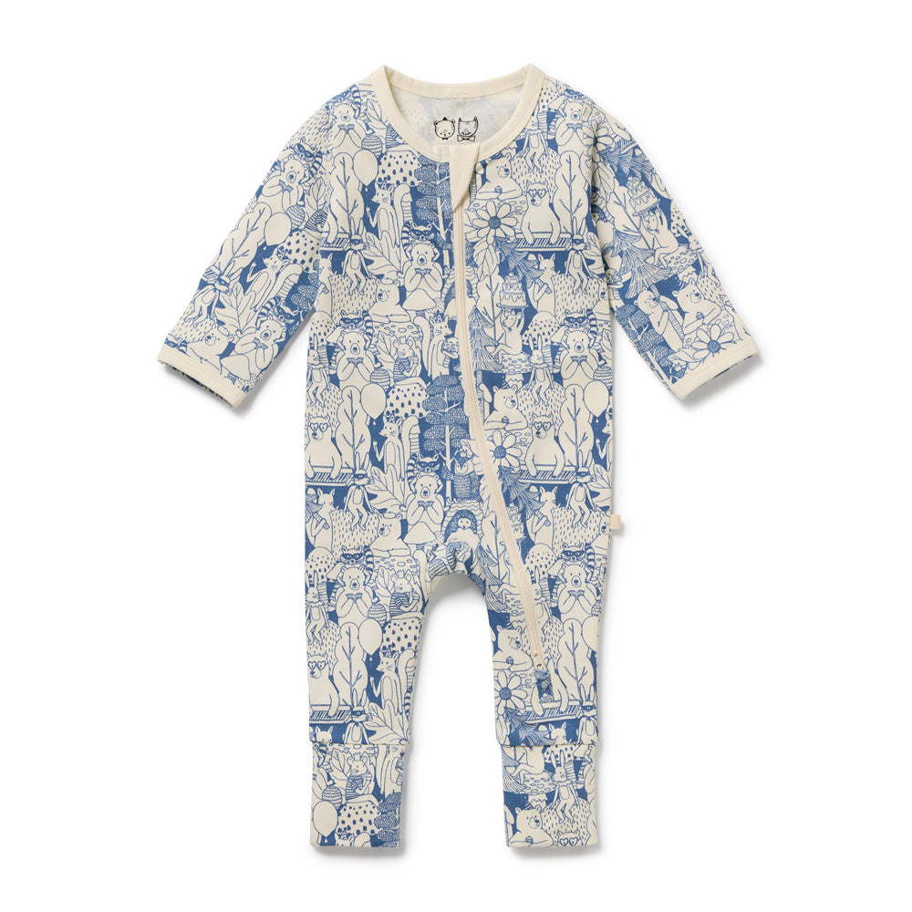 The Wilson & Frenchy Woodland Adventures Organic Zipsuit with Feet is a long-sleeved baby suit with a blue and white woodland pattern and an asymmetrical zipper from the neck to the left leg.