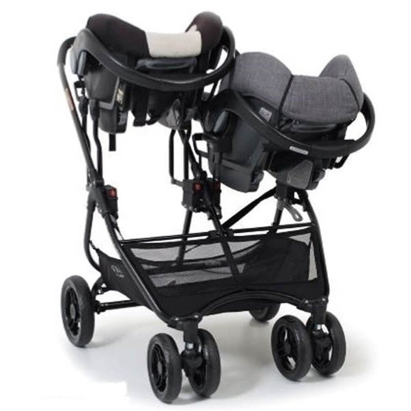 A set of Valco Baby Snap Ultra Duo Adaptors by Valco Baby connects two differently colored infant car seats—one dark with a white cushion, one gray—side by side on a double stroller frame with four wheels and an under-seat mesh storage basket.
