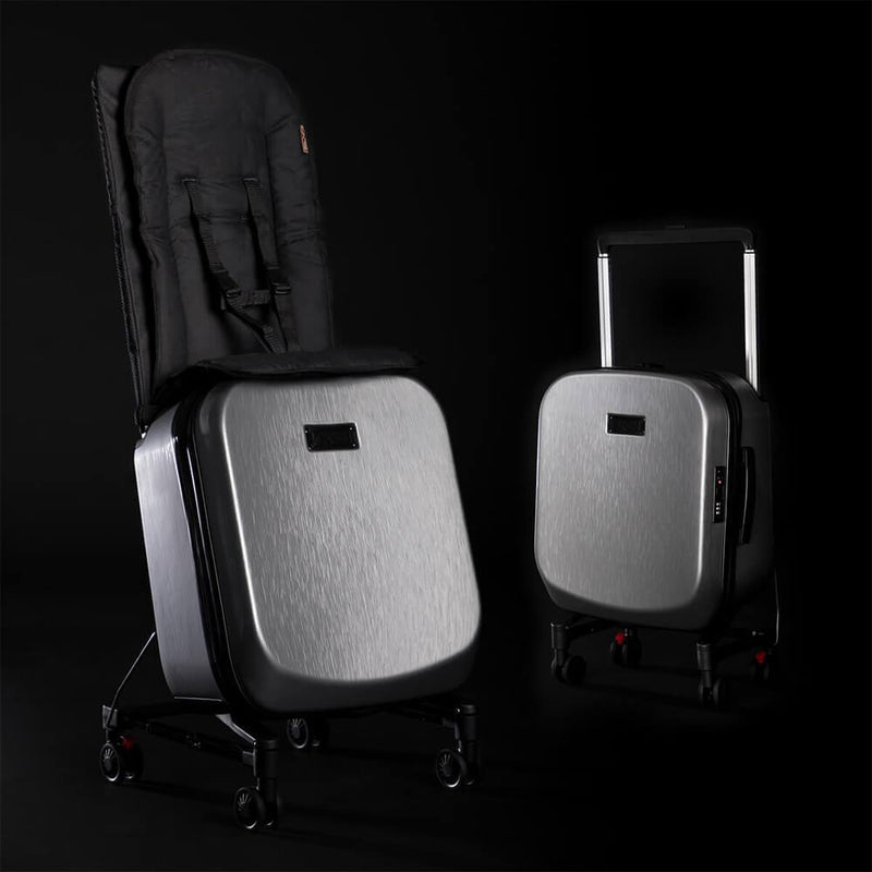 Two modern silver Mountain Buggy Skyrider Luxury Luggage cases are shown—one unfolded as a compact stroller with toddler seat, the other upright—both against a black background.