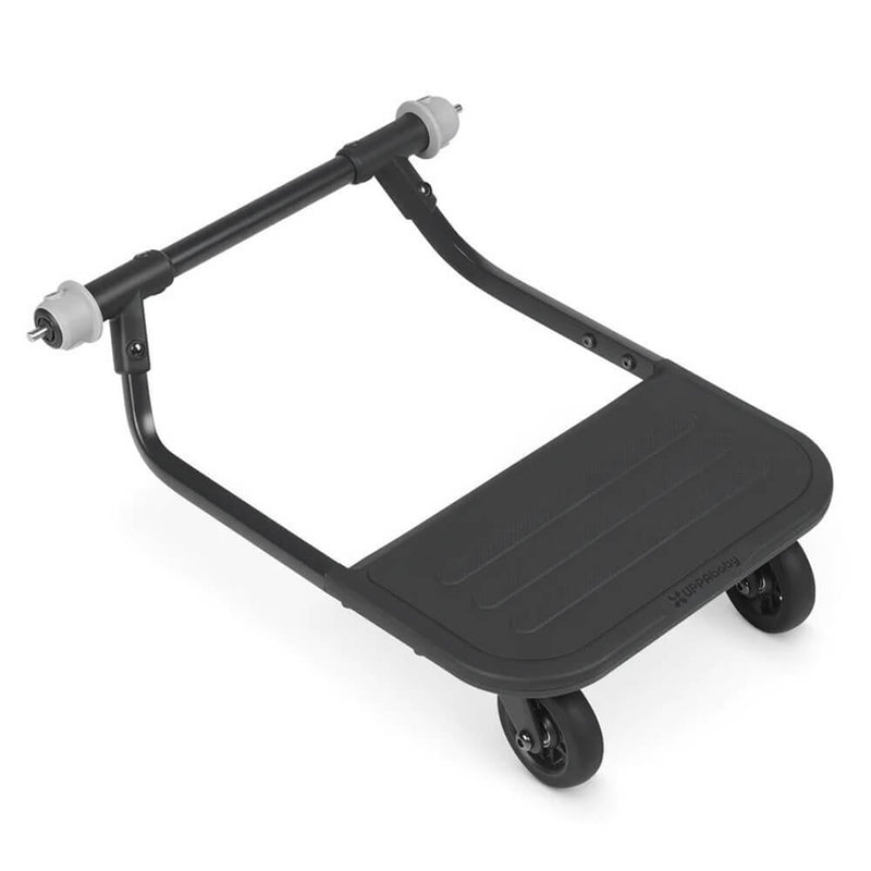 The UPPAbaby Piggyback Board Ridge is a black ride-along board with two small back wheels and front connectors for easy attachment to your RIDGE stroller, featuring a textured standing surface for your toddler’s comfort.