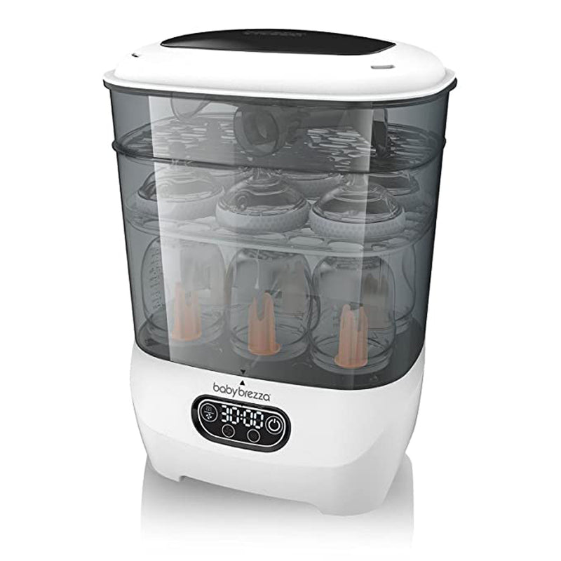 The Baby Brezza Steriliser & Dryer Advanced, featuring a transparent lid and digital control panel, displays bottles inside on a white surface. A built-in HEPA filter ensures hygienic drying for your baby’s essentials.