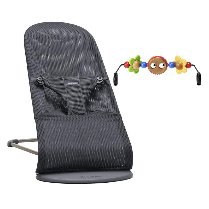 The BabyBjorn Bliss Bouncer With Toy Bar features a black mesh seat with a safety harness and an attached colorful toy bar with beads and flower shapes.