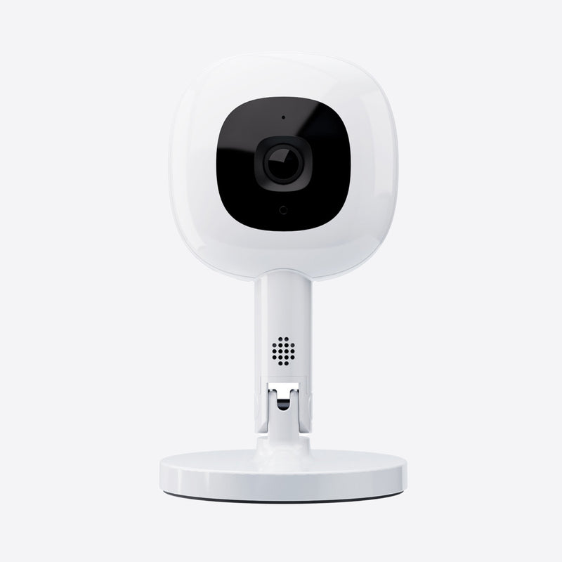 A Nanit Pro Baby Monitor + Flex Stand Duo by Nanit, featuring a white camera with a black central lens and round base for breathing motion monitoring, is shown against a plain light background.