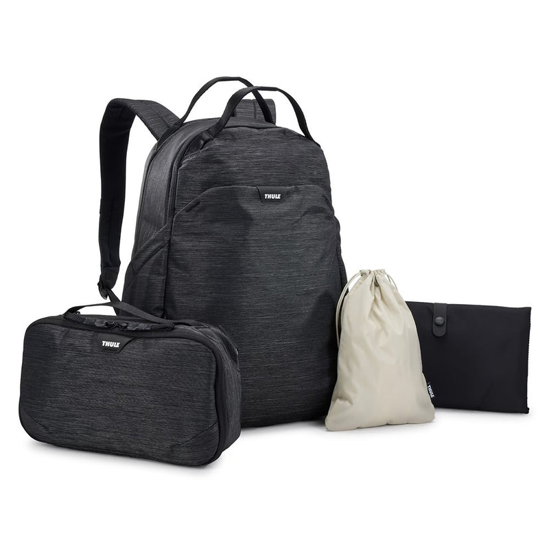 A black Thule Changing Backpack by Thule is shown with a matching travel case, a beige drawstring pouch, and a black foldable pouch with a removable pod, all set against a white background.