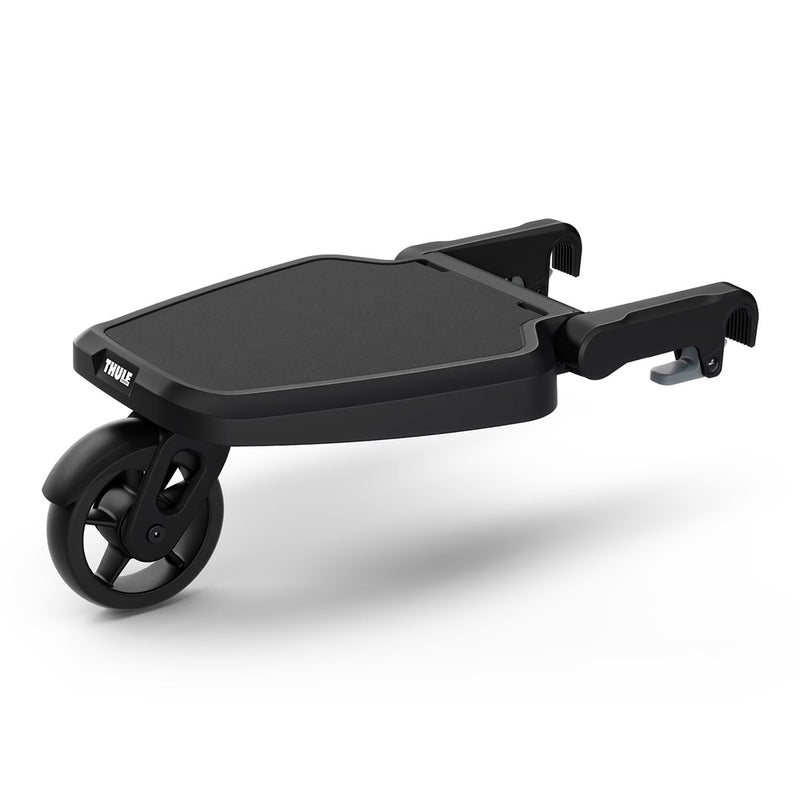 The Thule Rider Board by Thule is a black ride-along stroller attachment with one front wheel and two adjustable arms, allowing a child to stand while being pushed.