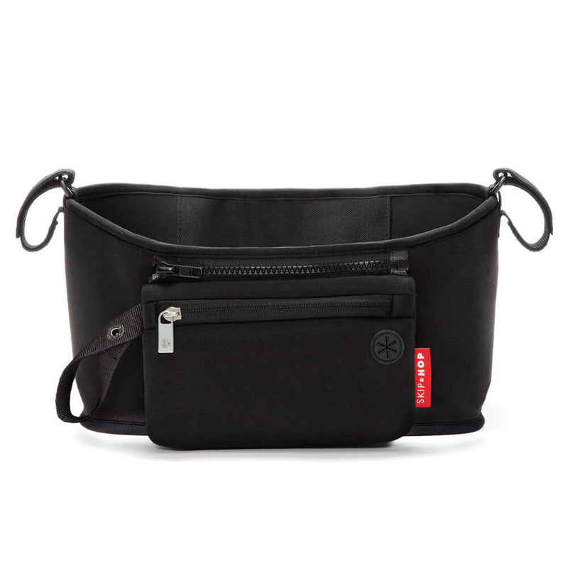 The Skip Hop Grab & Go Stroller Organiser is a black neoprene bag with a zippered front pouch, red Skip Hop tag, adjustable side straps, and round logo—ideal for busy parents to keep essentials organized on the go.